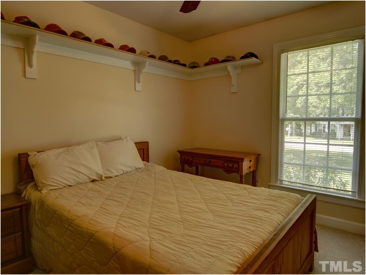 2016 Travianna Court Raleigh, NC 27609 - Photo 12 of 19 a bed sitting in a bedroom next to a window