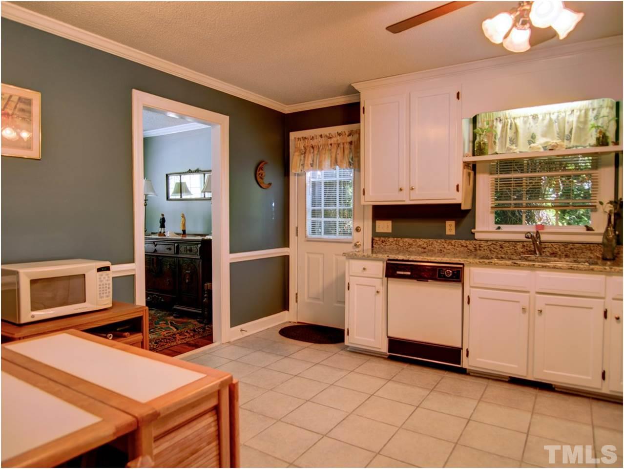 2016 Travianna Court Raleigh, NC 27609 - Photo 10 of 19 a kitchen with a stove and white cabinets