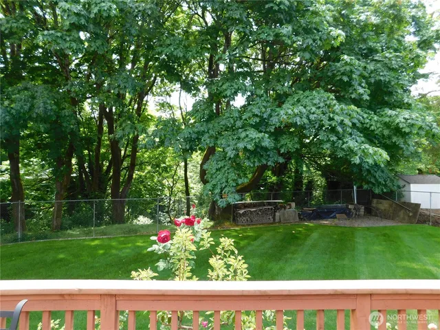 a view of yard with swimming pool and green space