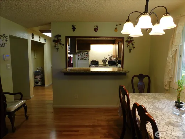 a view of a dining room with furniture and chandelier
