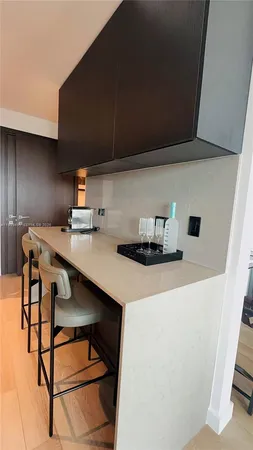 a large kitchen with a table and chairs