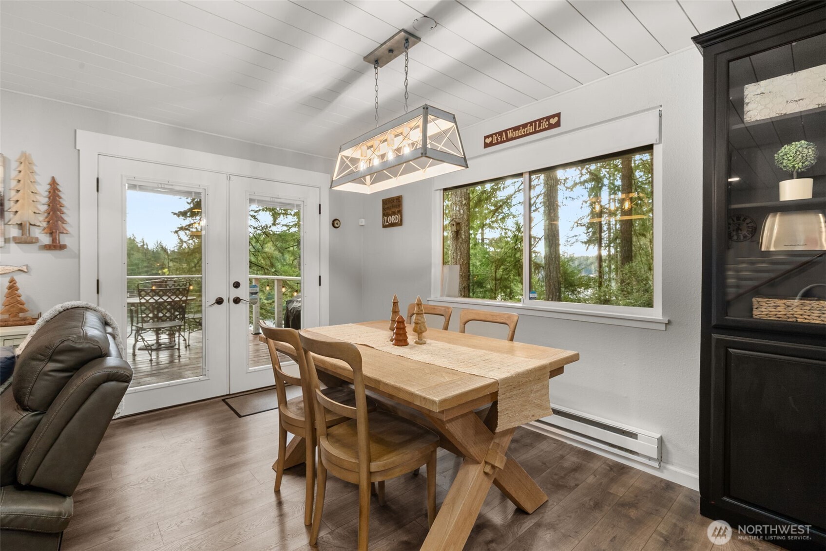 2800 East Phillips Lake Loop Road Shelton, WA 98584 - Photo 11 of 40 a view of a dining room with furniture large windows and wooden floor