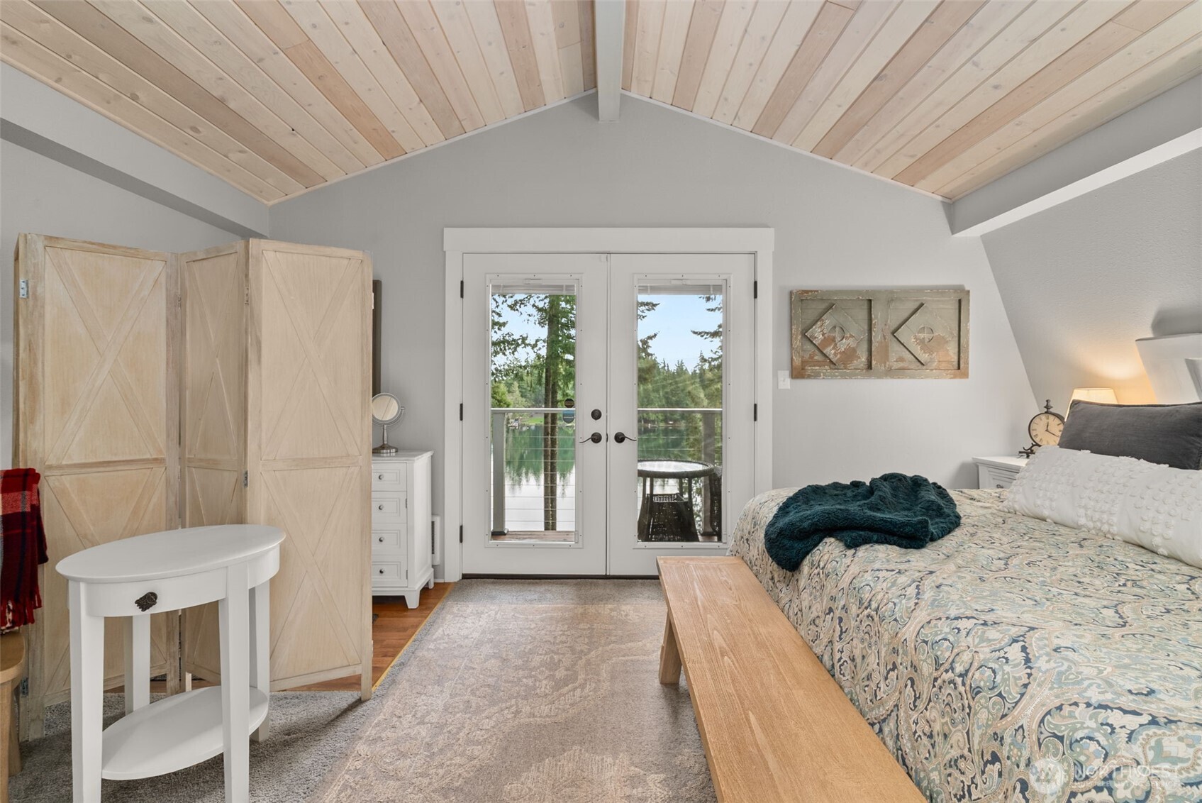 2800 East Phillips Lake Loop Road Shelton, WA 98584 - Photo 17 of 40 a bedroom with a bed a rug and a large window