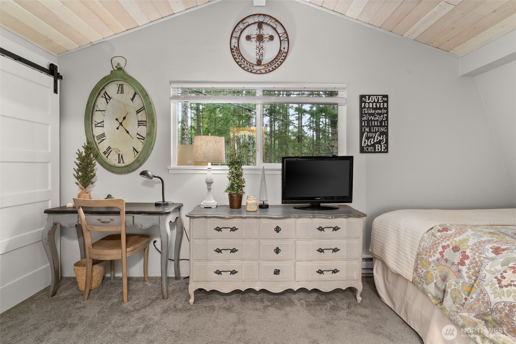 2800 East Phillips Lake Loop Road Shelton, WA 98584 - Photo 19 of 40 a bedroom with a large window and a clock on a dresser