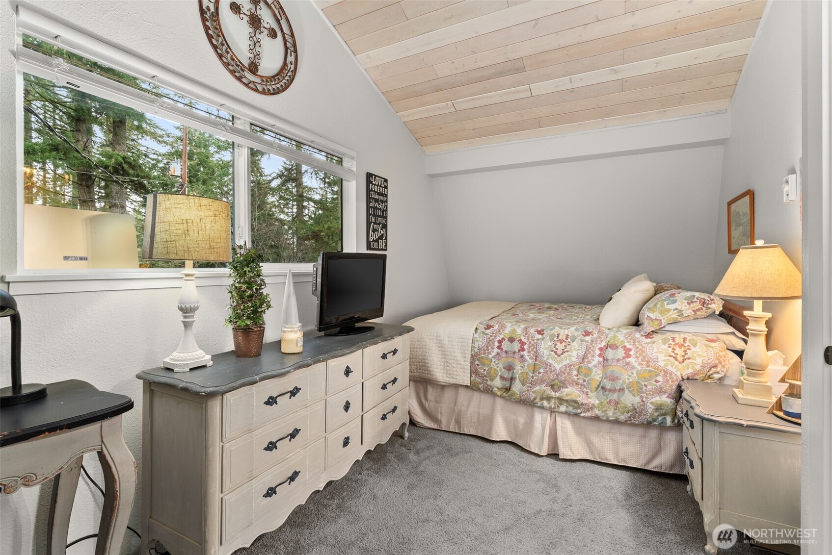 2800 East Phillips Lake Loop Road Shelton, WA 98584 - Photo 20 of 40 a bedroom with a bed and a flat tv screen on dresser