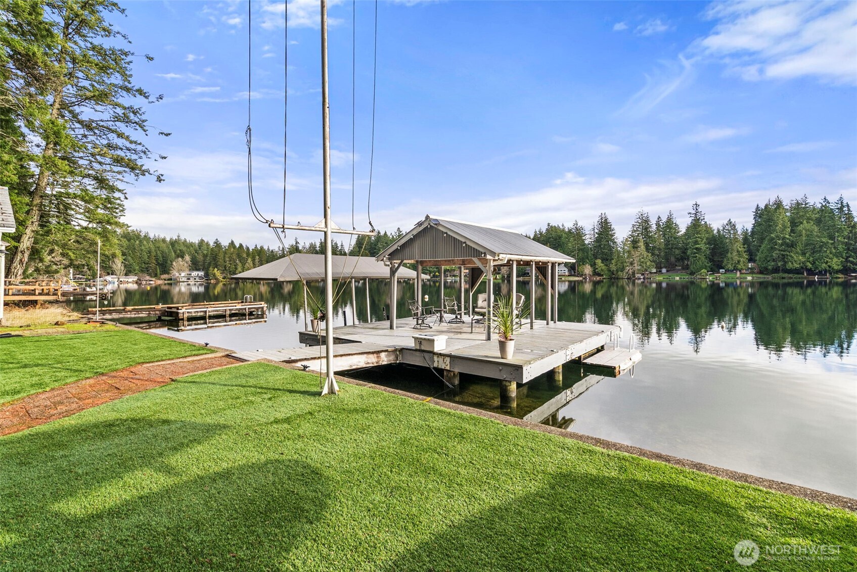 2800 East Phillips Lake Loop Road Shelton, WA 98584 - Photo 28 of 40 a view of a lake with lawn chairs and a big yard
