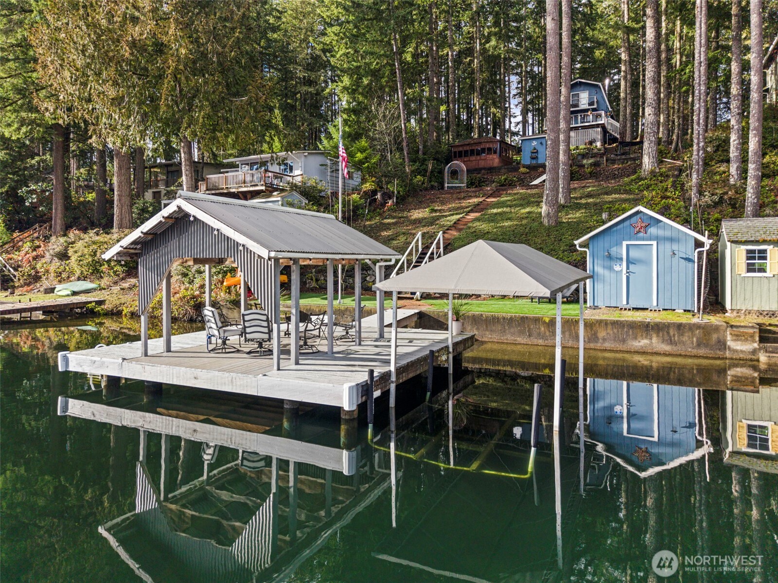 2800 East Phillips Lake Loop Road Shelton, WA 98584 - Photo 35 of 40 a view of house with dinning table and chairs under an umbrella