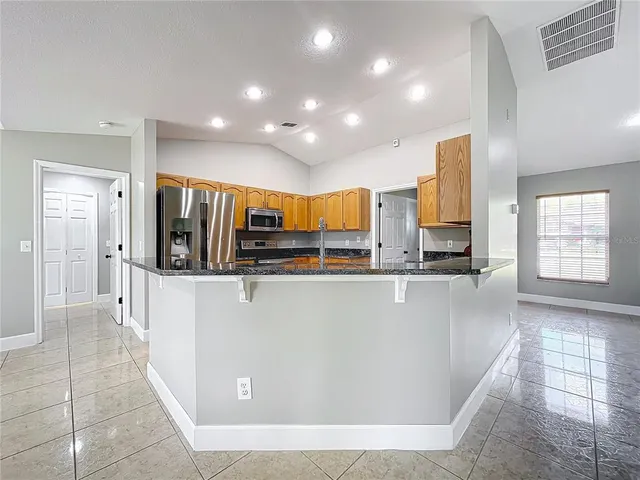a living room with furniture and a glass door