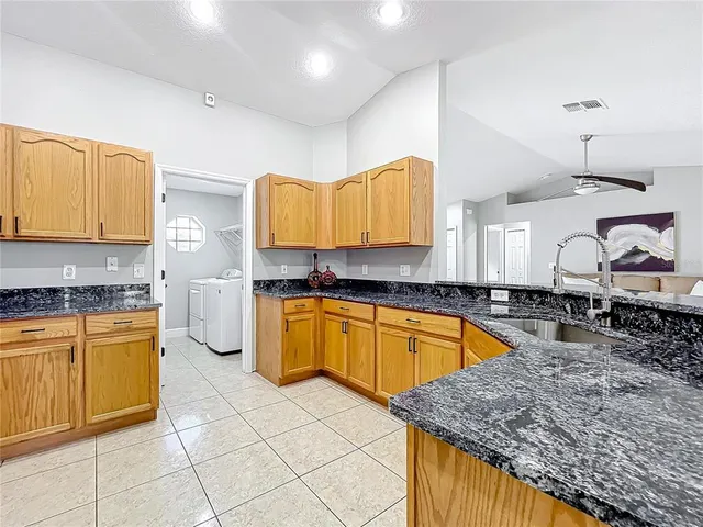 a kitchen with stainless steel appliances granite countertop a sink and cabinets