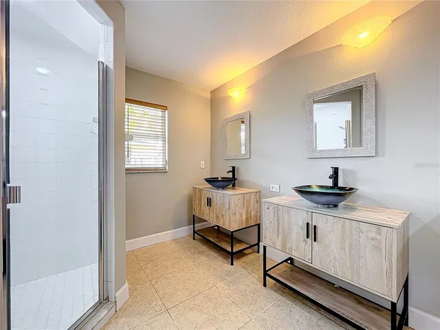 a view of an empty room with a ceiling fan and window