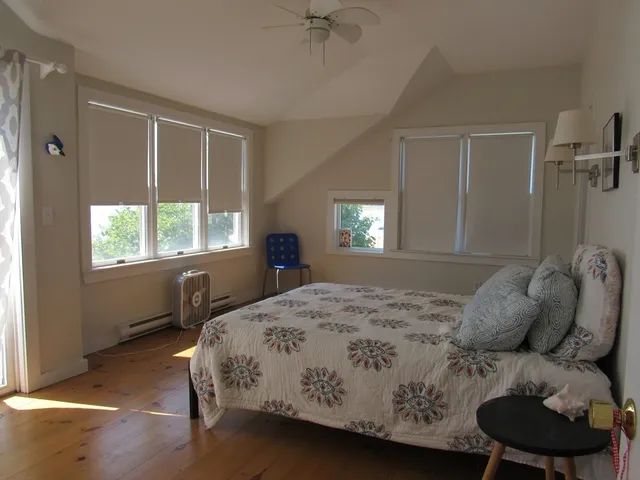 a bedroom with a bed window and a table