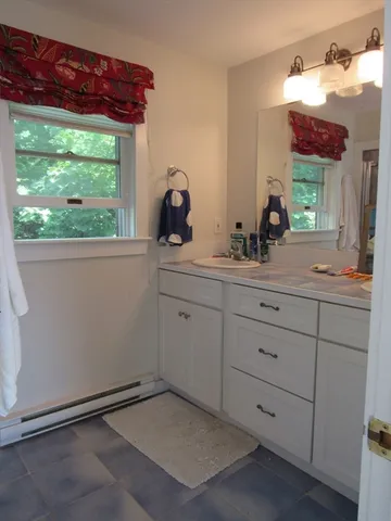 a room with a sink and a mirror