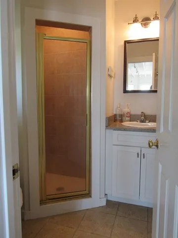 a bathroom with a sink a mirror and shower
