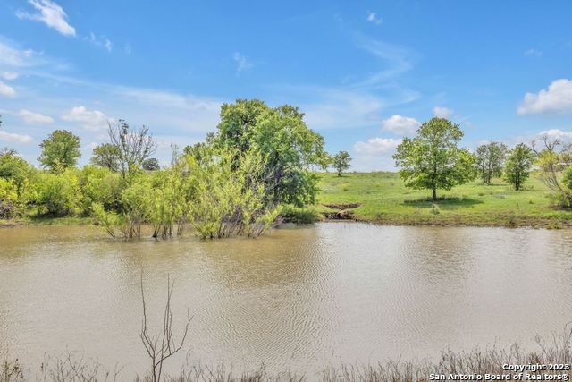 16547 East Gable Road St. Hedwig, TX 78152 - Photo 2 of 38 a view of a lake from a yard