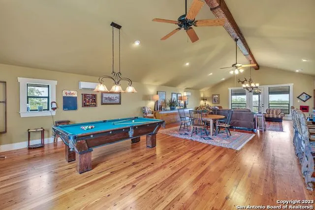 a living room with furniture a chandelier and a large window