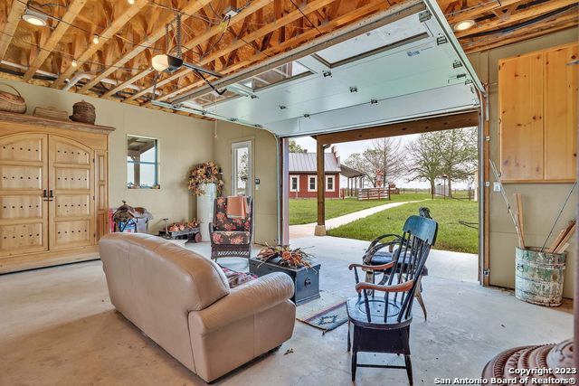 16547 East Gable Road St. Hedwig, TX 78152 - Photo 30 of 38 a living room with furniture a chandelier and a large window