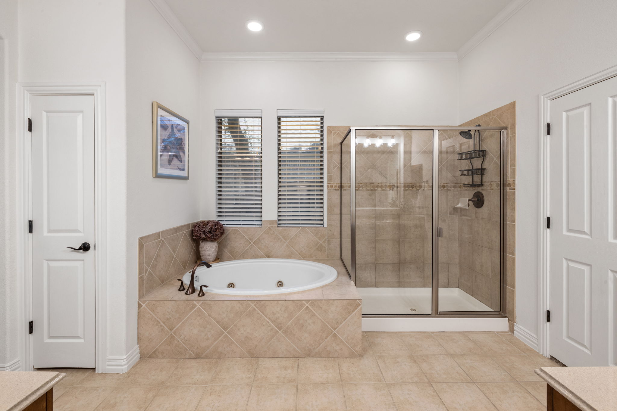 1124 Castle Path Round Rock, TX 78681 - Photo 22 of 40 Indulge in a tranquil retreat featuring a spacious soaking tub and a sleek, tiled shower.