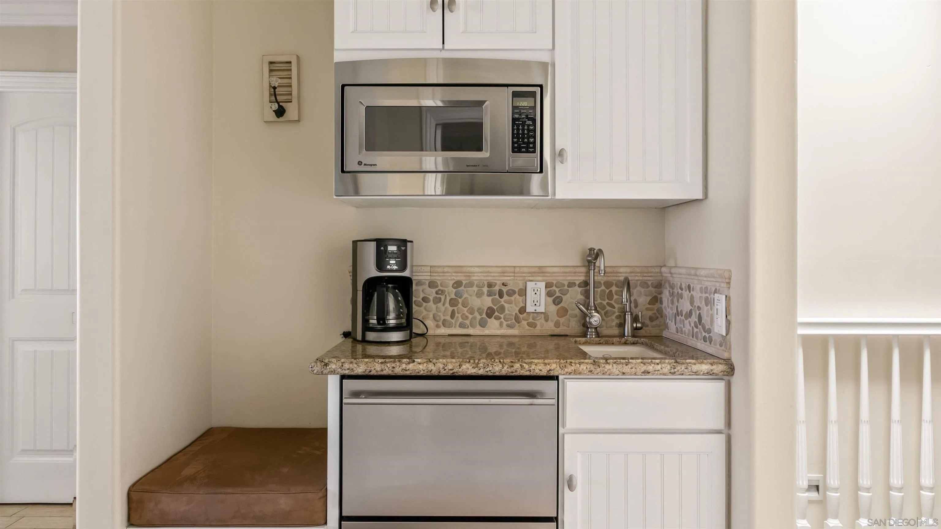 3285 Ocean Front Walk, Unit 3 San Diego, CA 92109 - Photo 22 of 38 a kitchen with granite countertop white cabinets and stainless steel appliances