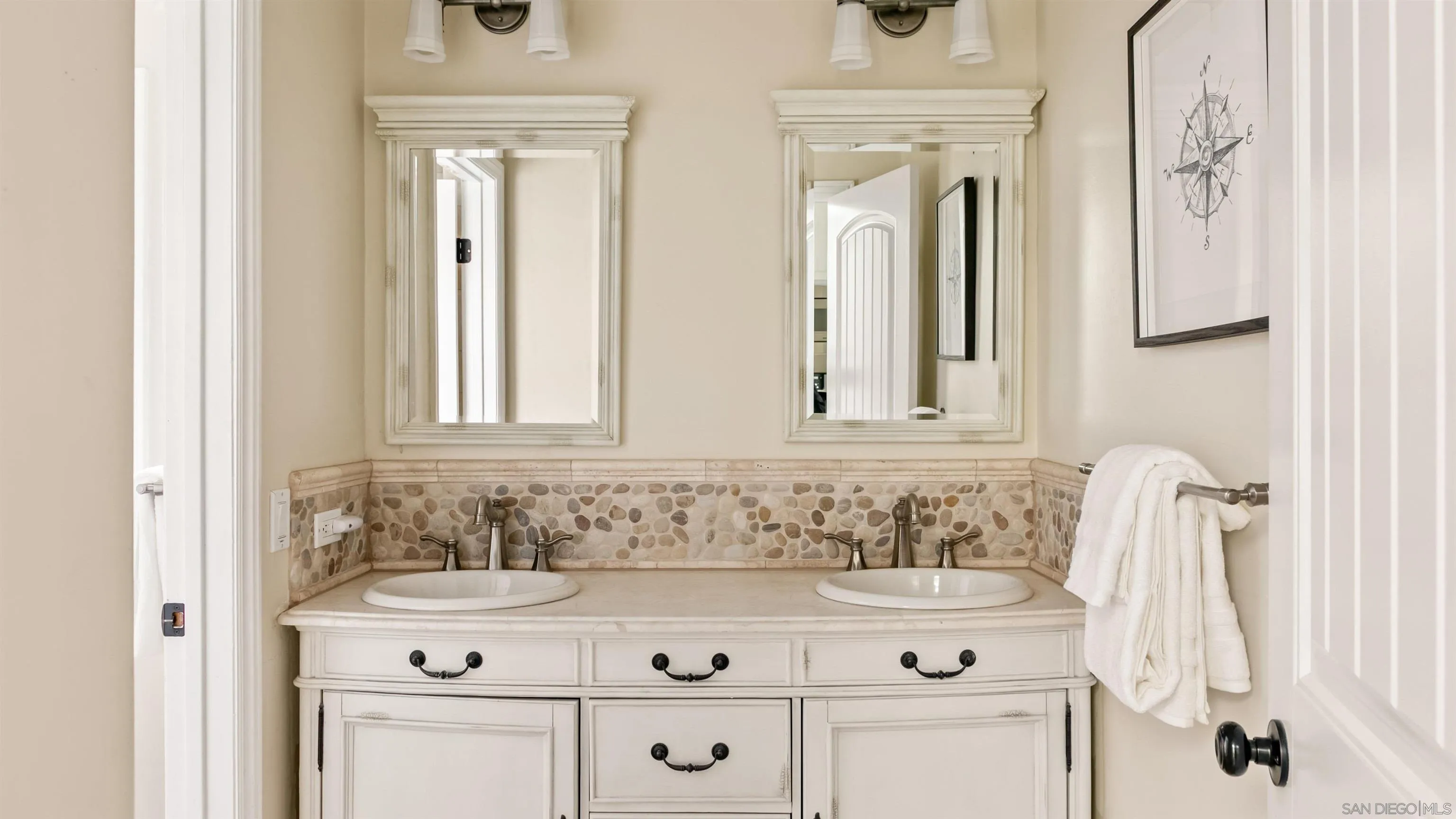 3285 Ocean Front Walk, Unit 3 San Diego, CA 92109 - Photo 23 of 38 a bathroom with a sink vanity and a mirror