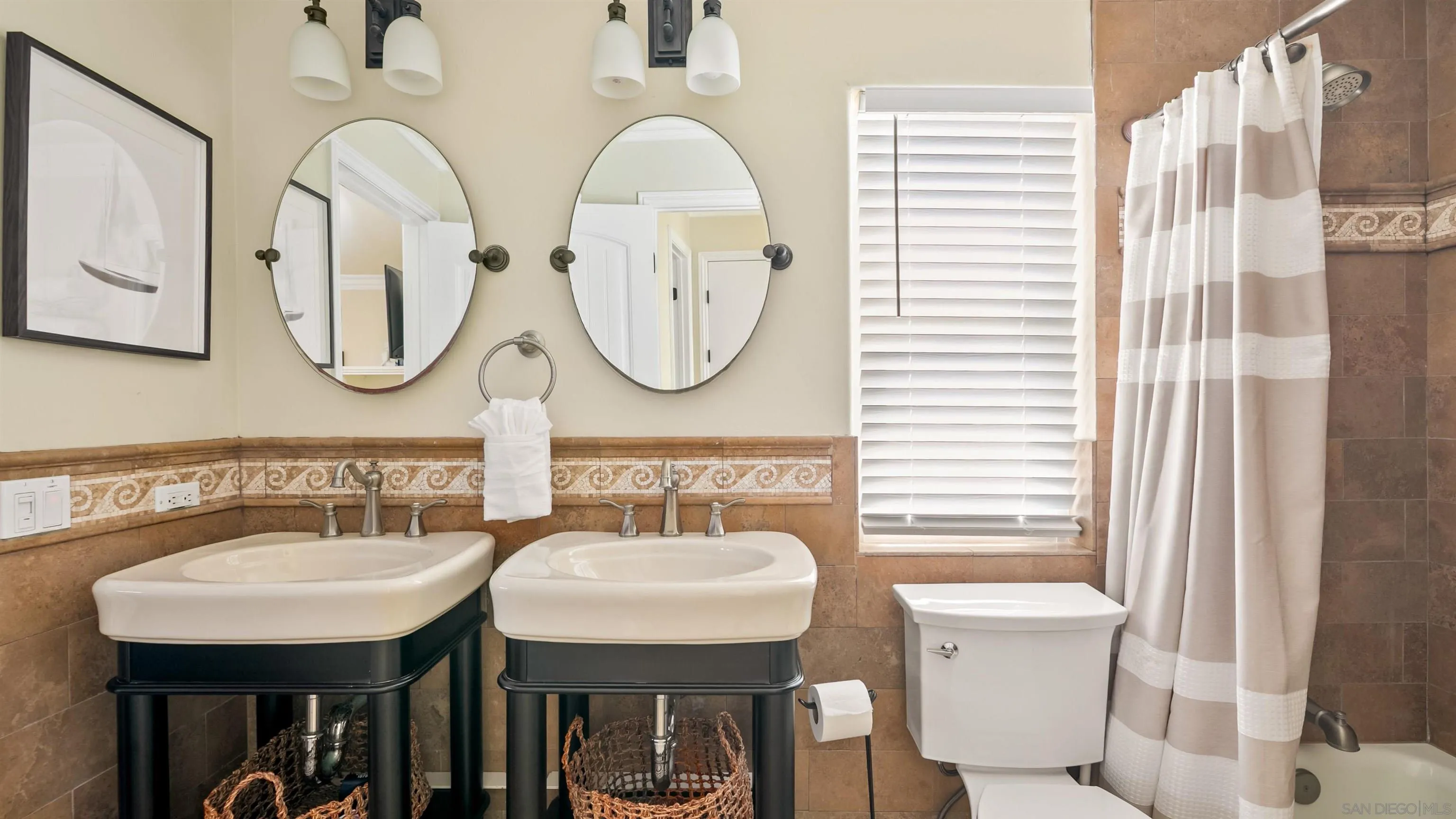 3285 Ocean Front Walk, Unit 3 San Diego, CA 92109 - Photo 26 of 38 a bathroom with a sink a mirror a toilet and a window