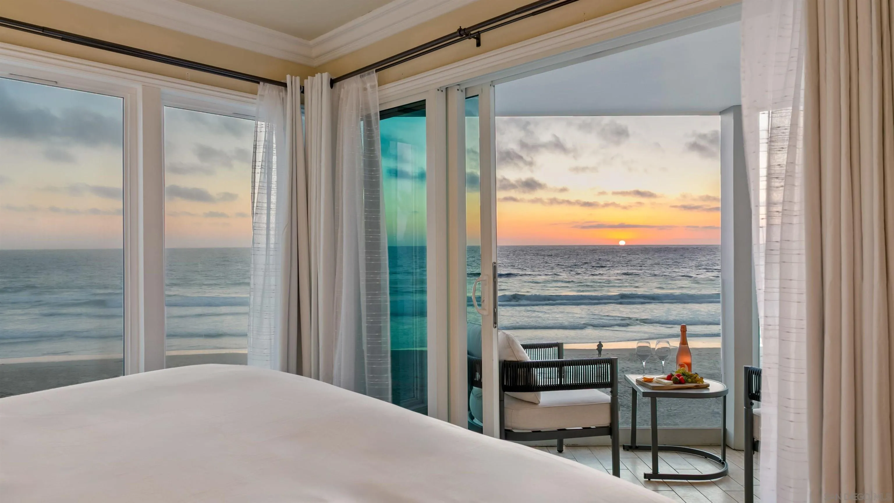 3285 Ocean Front Walk, Unit 3 San Diego, CA 92109 - Photo 6 of 38 a bedroom with a bed and glass window