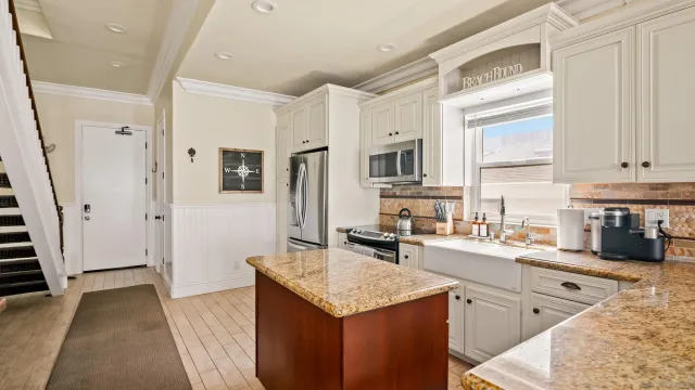 a kitchen with stainless steel appliances granite countertop a stove a sink dishwasher and a refrigerator