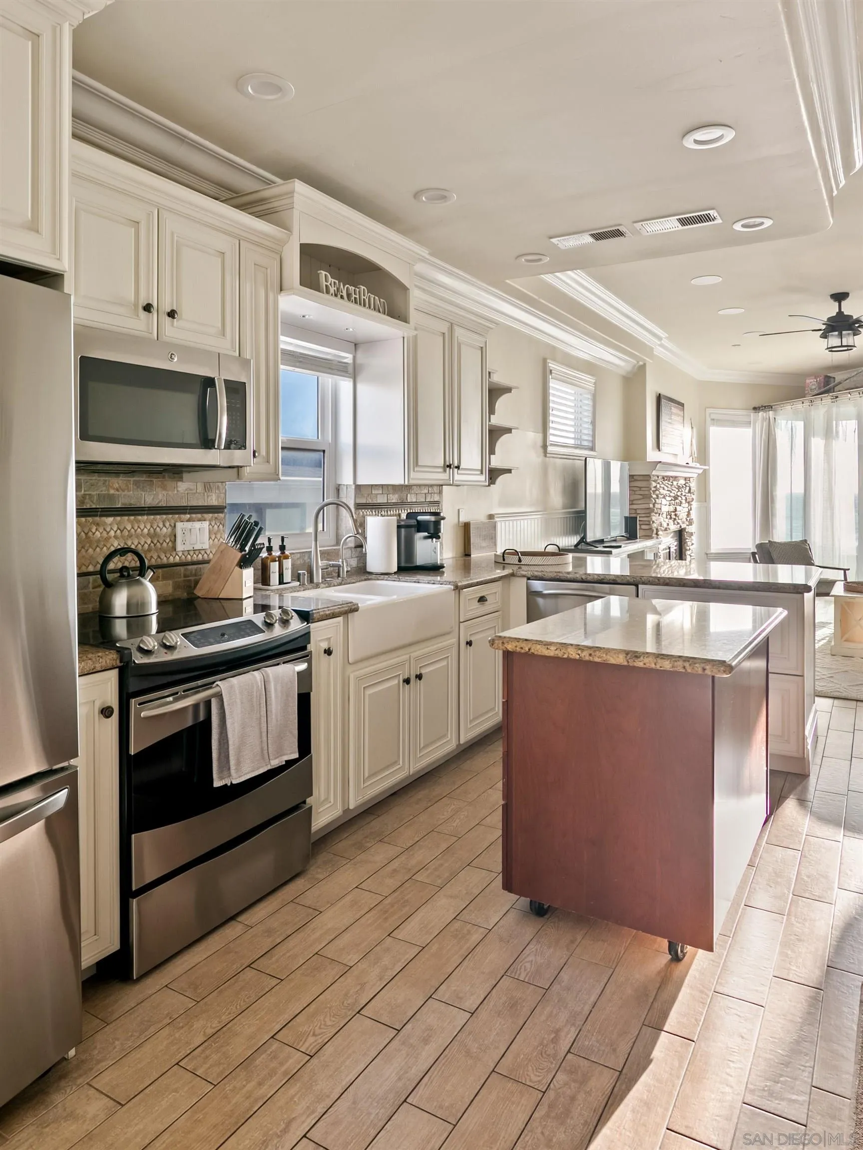 3285 Ocean Front Walk, Unit 3 San Diego, CA 92109 - Photo 8 of 38 a kitchen with stainless steel appliances granite countertop a stove a sink dishwasher and a refrigerator
