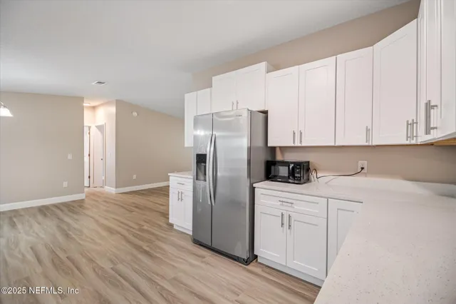 a kitchen with stainless steel appliances granite countertop a refrigerator and a stove top oven