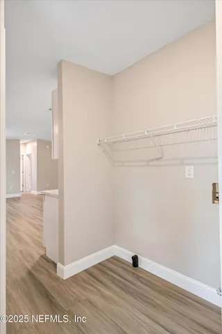 a view of a room with wooden floor