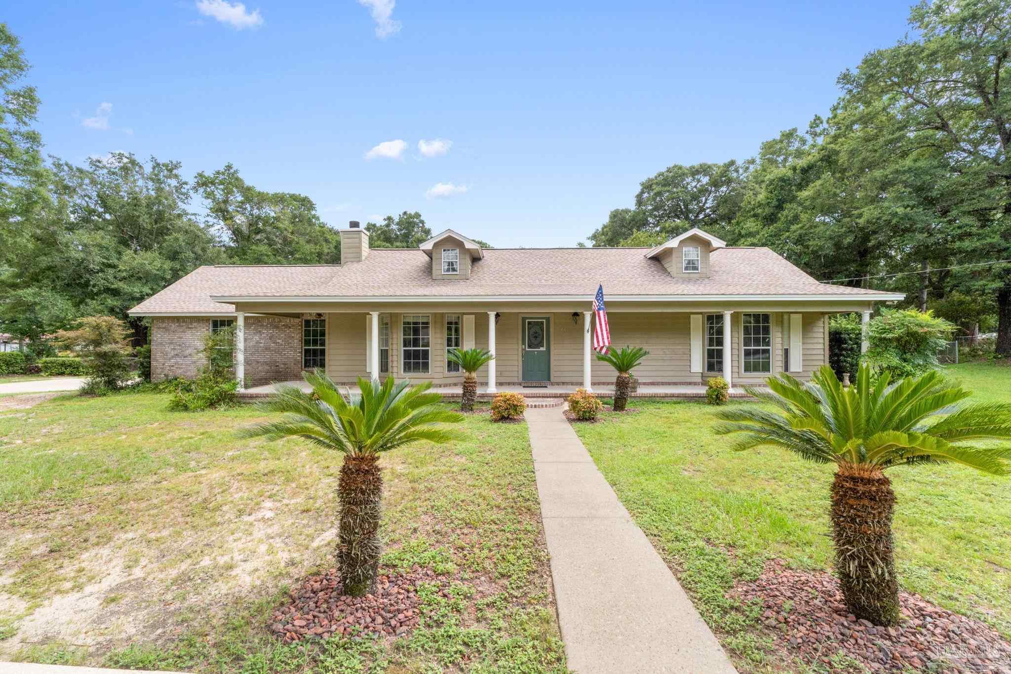 a front view of a house with garden
