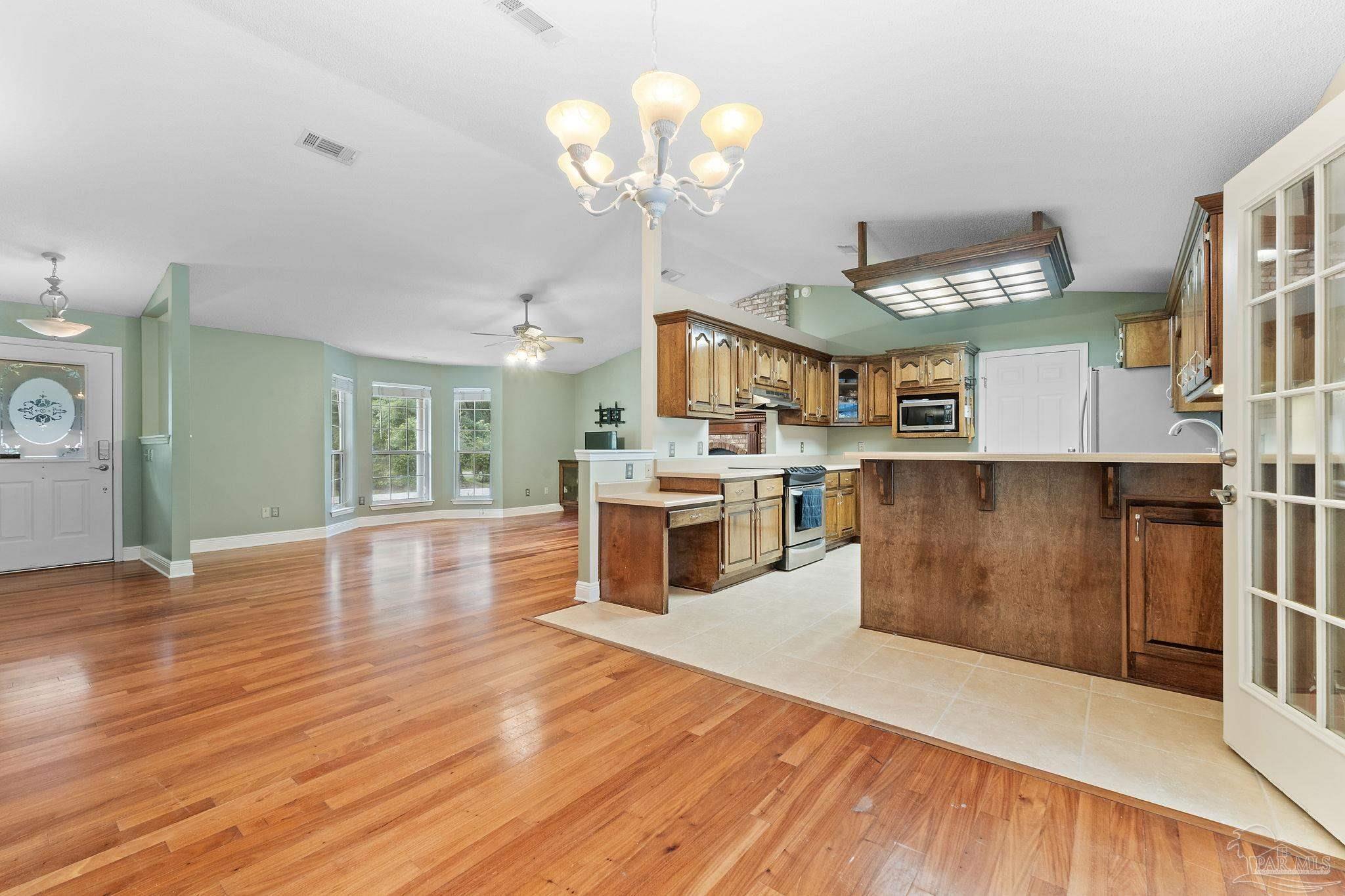 5645 Windham Road Milton, FL 32570 - Photo 11 of 40 a view of a kitchen with cabinets and wooden floor