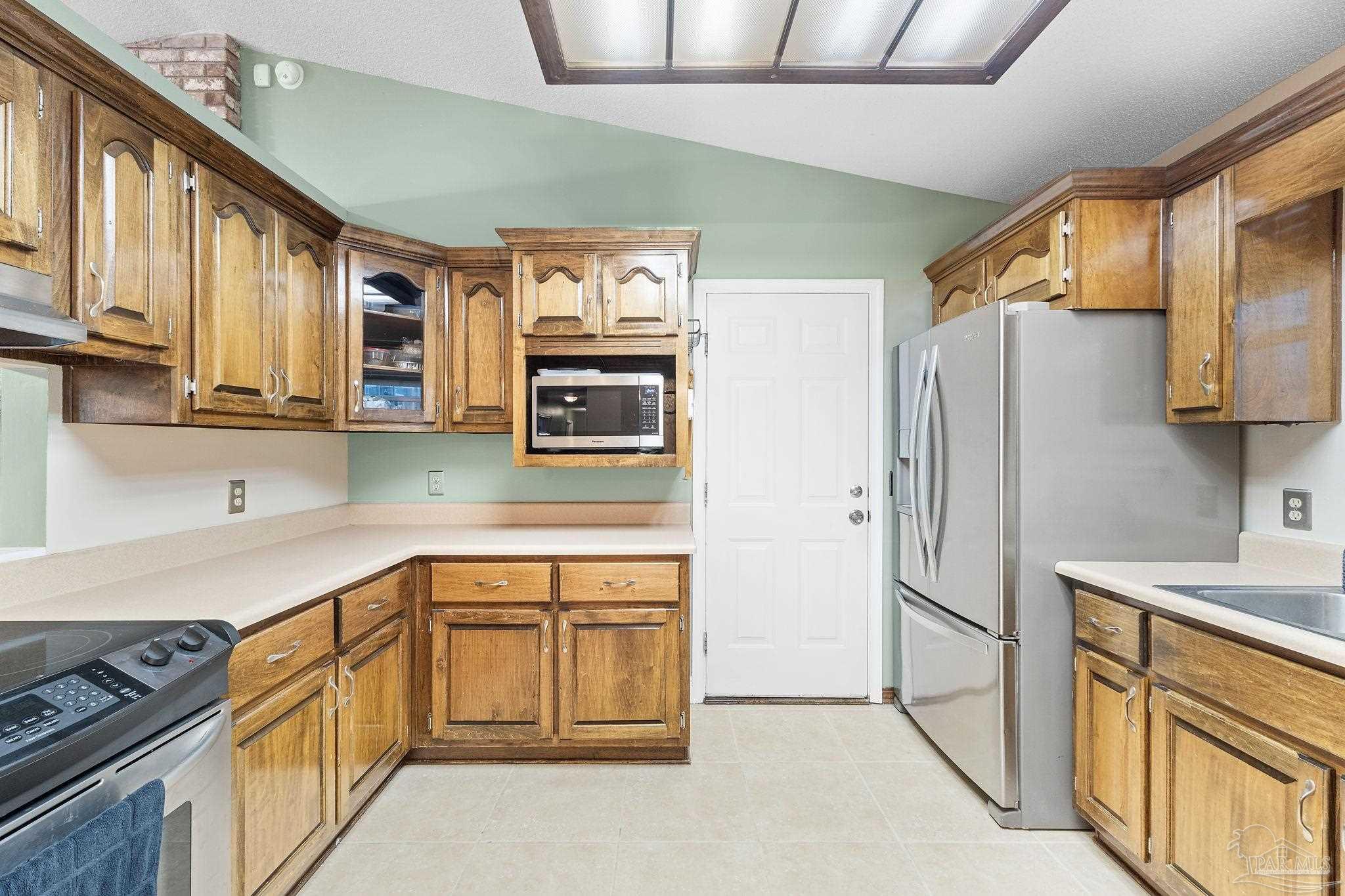 5645 Windham Road Milton, FL 32570 - Photo 14 of 40 a kitchen with stainless steel appliances granite countertop a refrigerator sink and stove