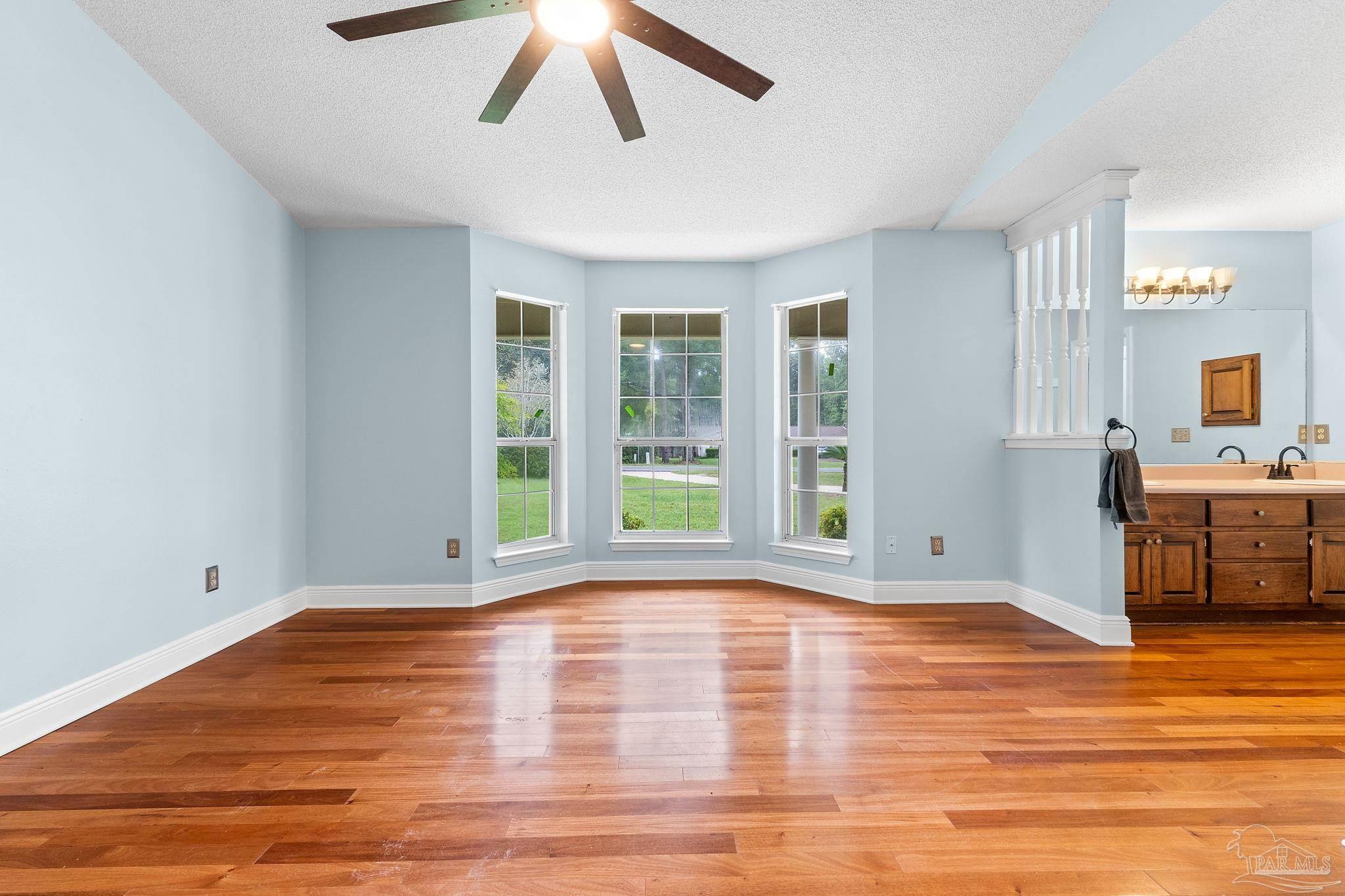 5645 Windham Road Milton, FL 32570 - Photo 17 of 40 a view of an empty room with window and wooden floor