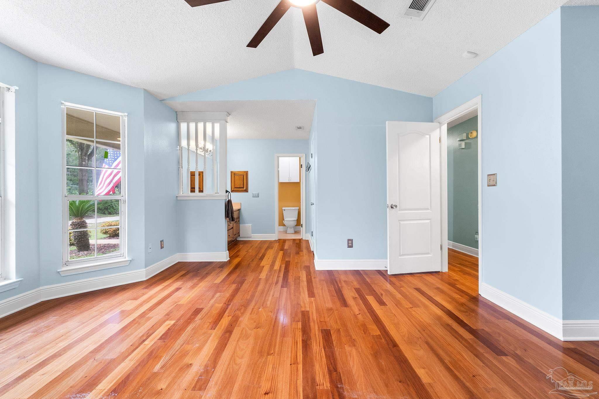 5645 Windham Road Milton, FL 32570 - Photo 18 of 40 a view of empty room with wooden floor and window