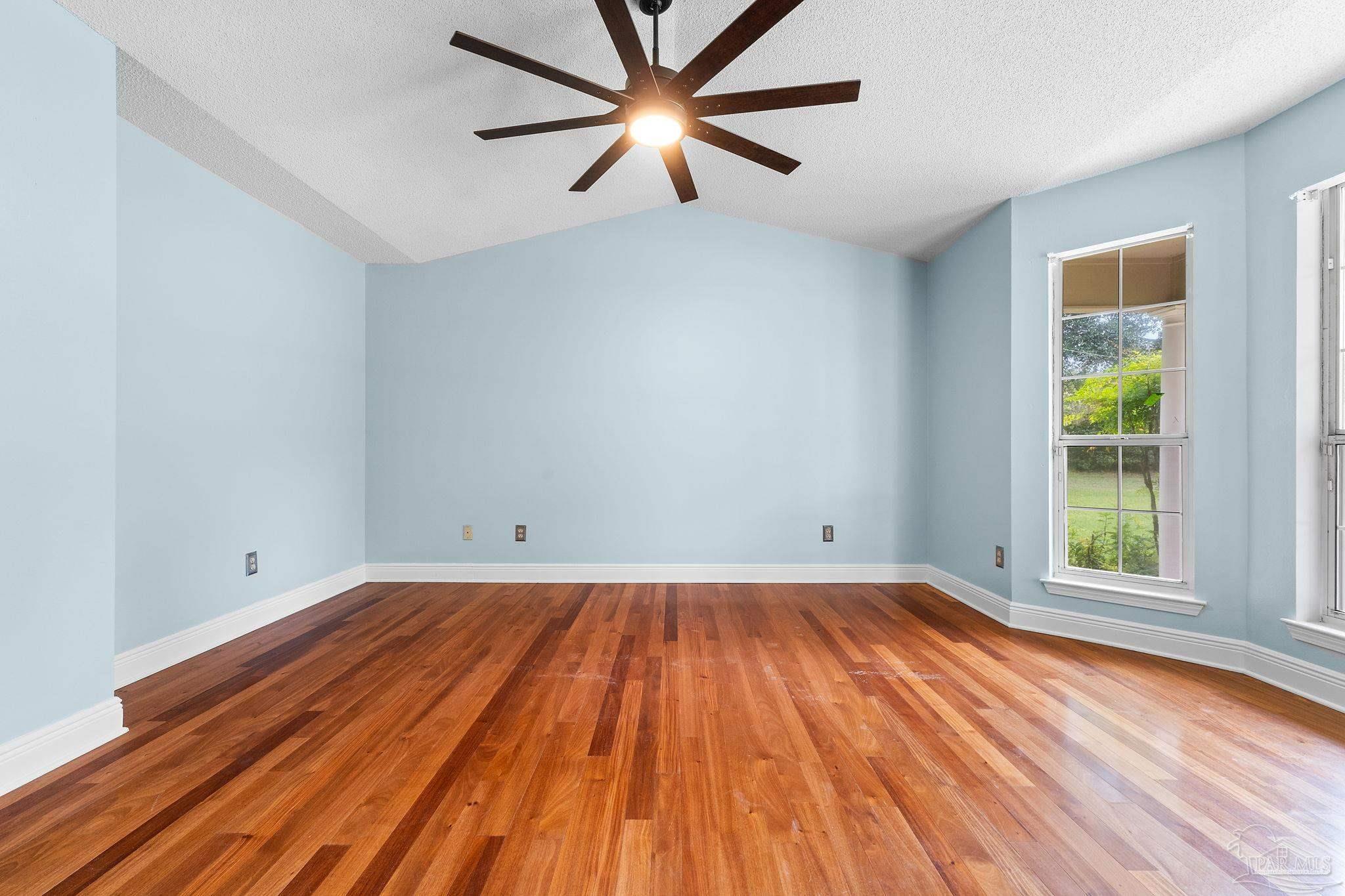 5645 Windham Road Milton, FL 32570 - Photo 19 of 40 wooden floor in an empty room with a window