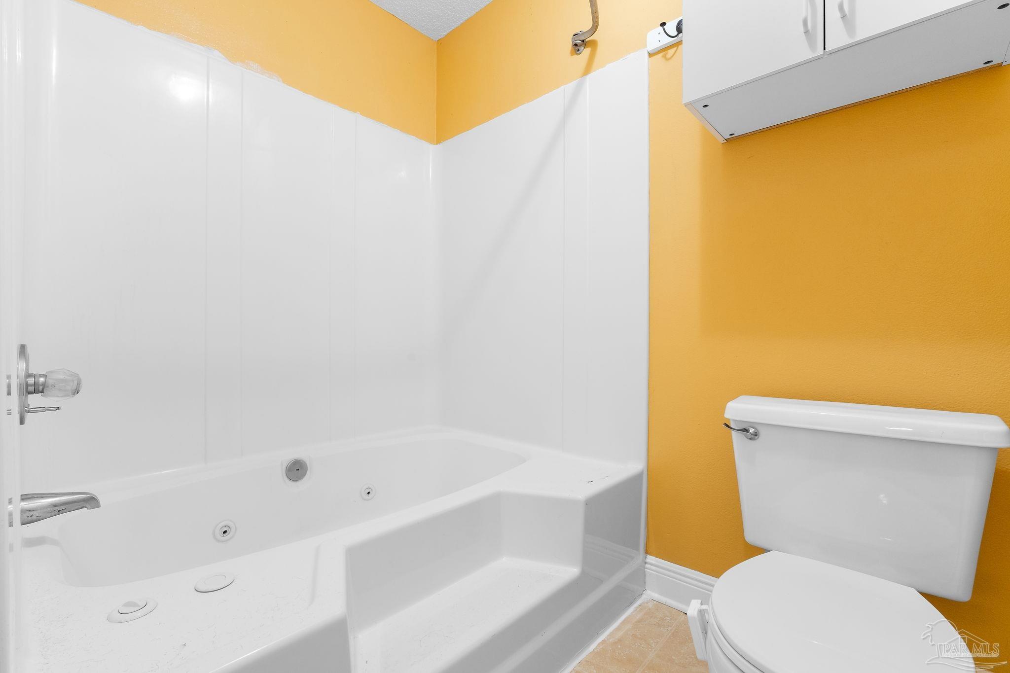 5645 Windham Road Milton, FL 32570 - Photo 21 of 40 a bathroom with a toilet and a bathtub