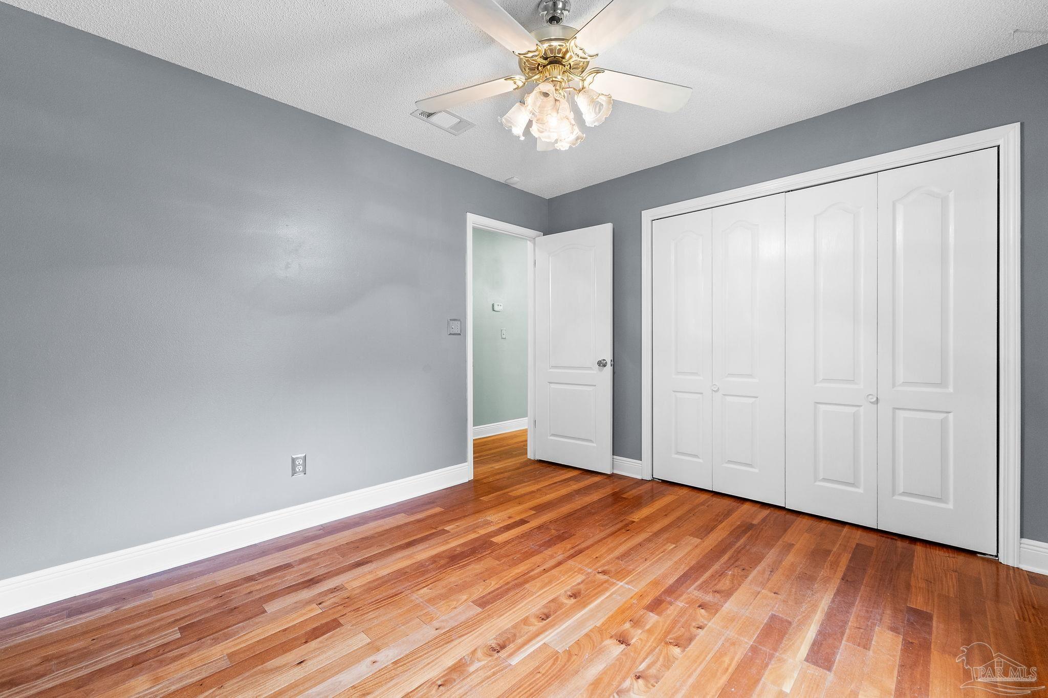 5645 Windham Road Milton, FL 32570 - Photo 23 of 40 wooden floor in an empty room with a window