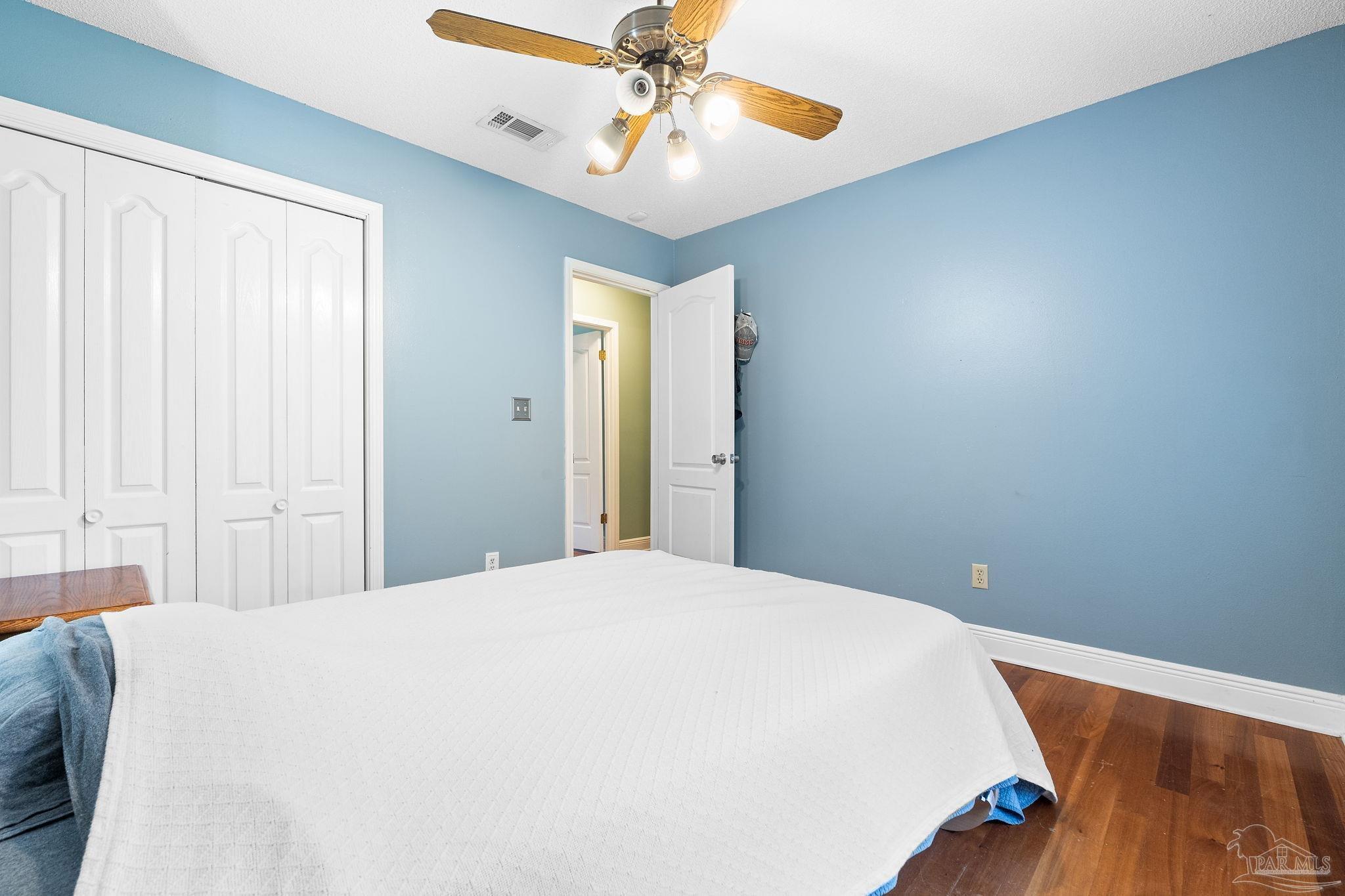 5645 Windham Road Milton, FL 32570 - Photo 25 of 40 a bedroom with a bed and a chandelier