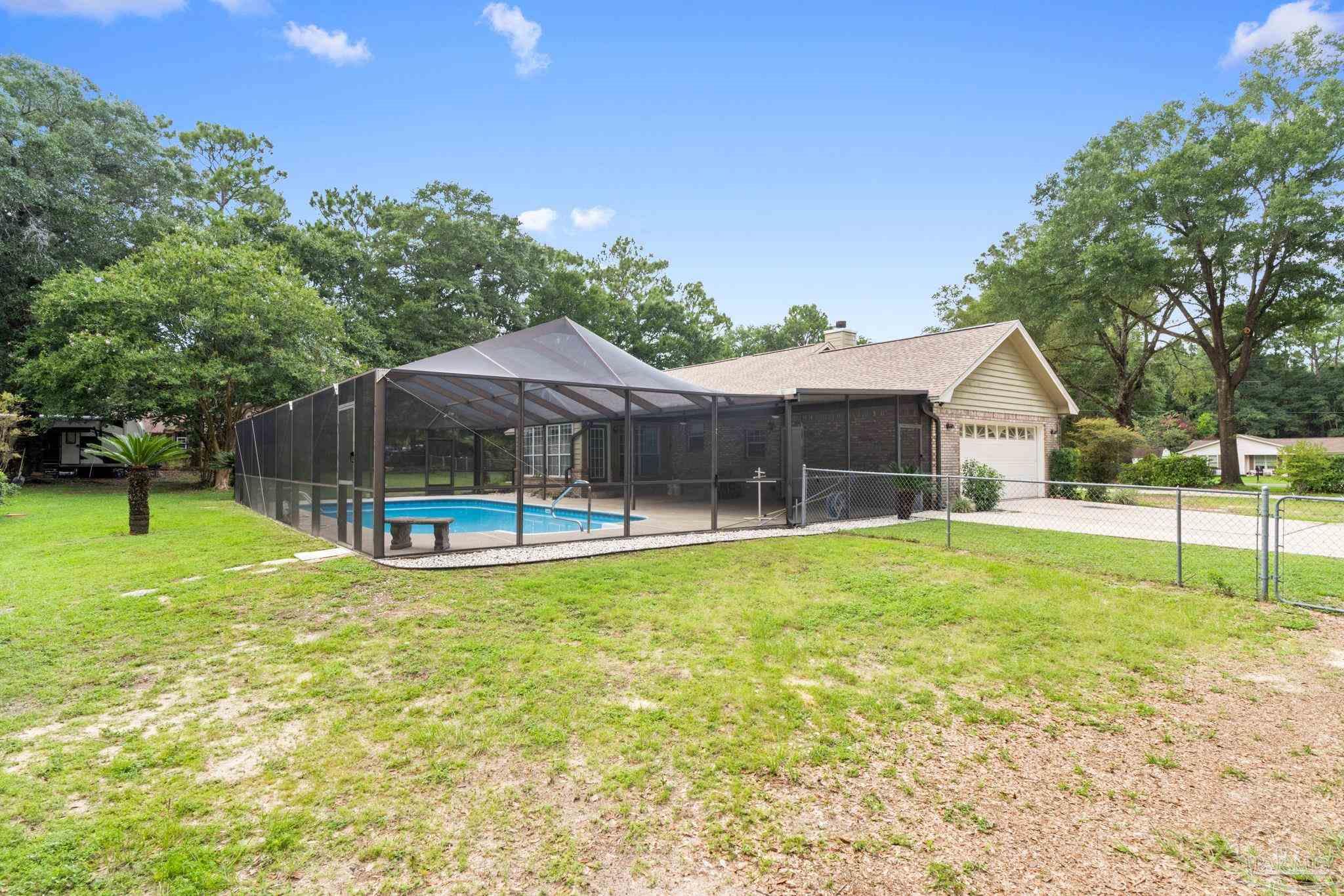 5645 Windham Road Milton, FL 32570 - Photo 29 of 40 a house view with a sitting space and garden