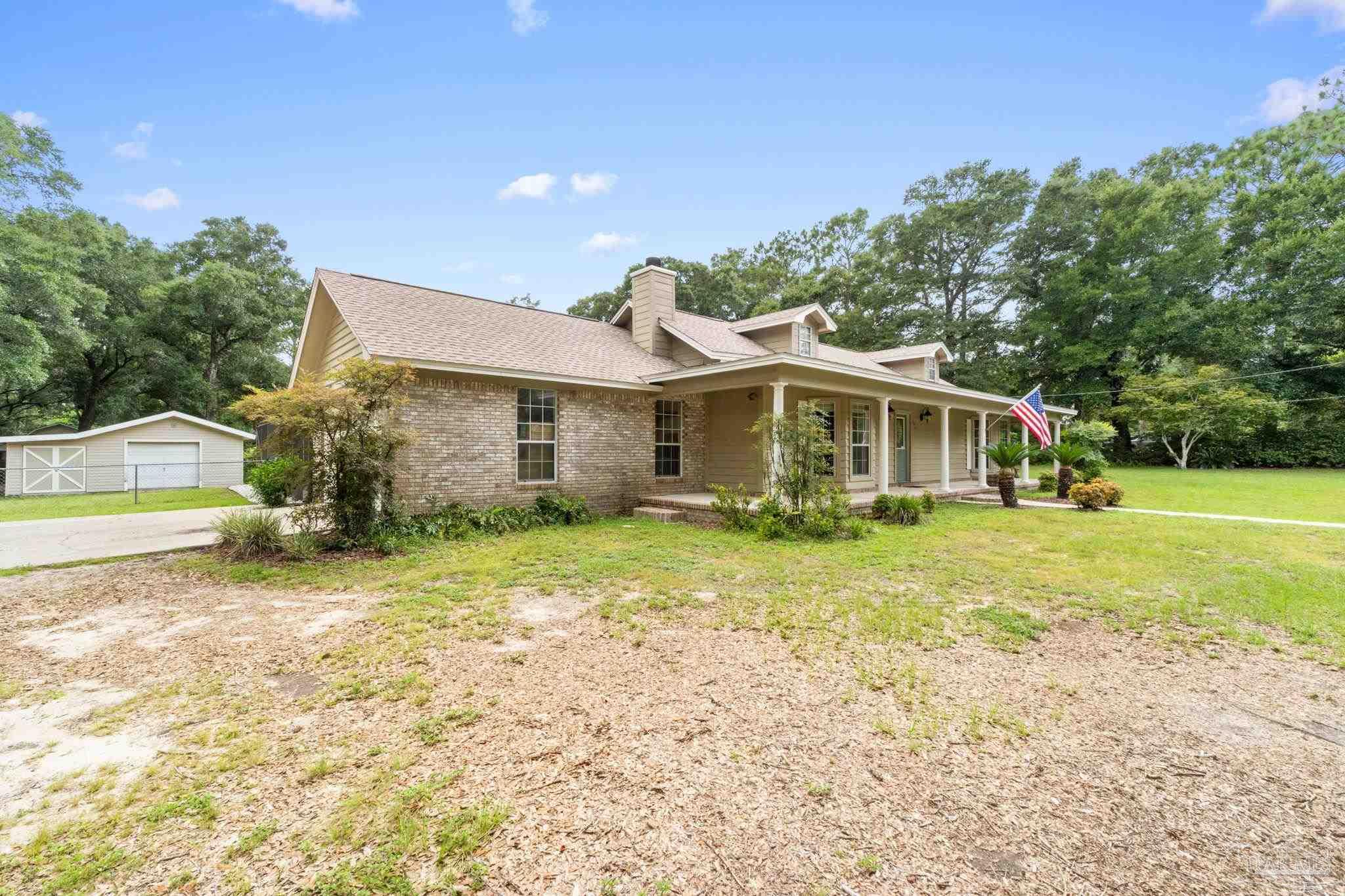 5645 Windham Road Milton, FL 32570 - Photo 3 of 40 a view of a house with backyard and a tree