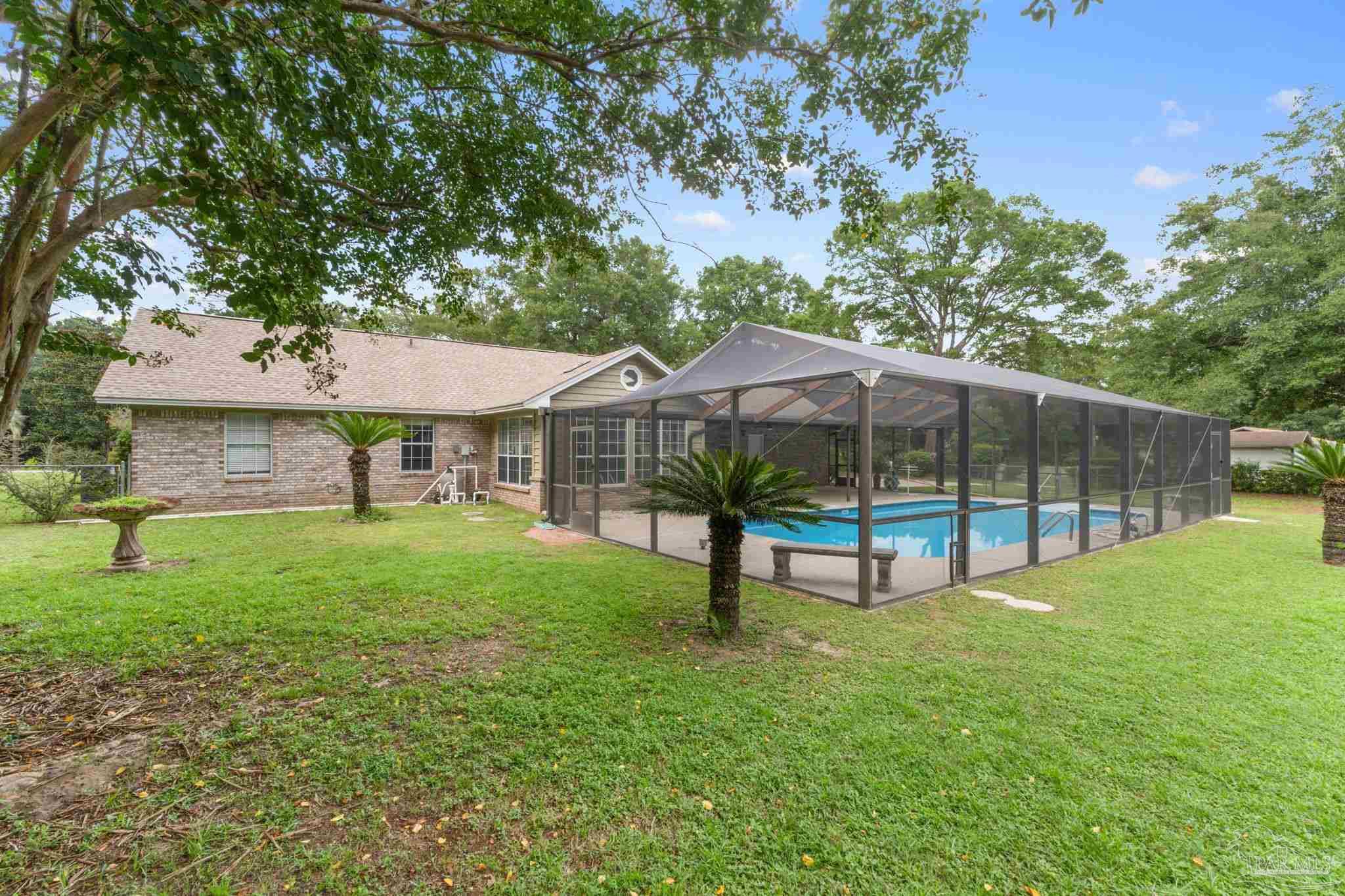 5645 Windham Road Milton, FL 32570 - Photo 31 of 40 a view of a house with backyard and garden