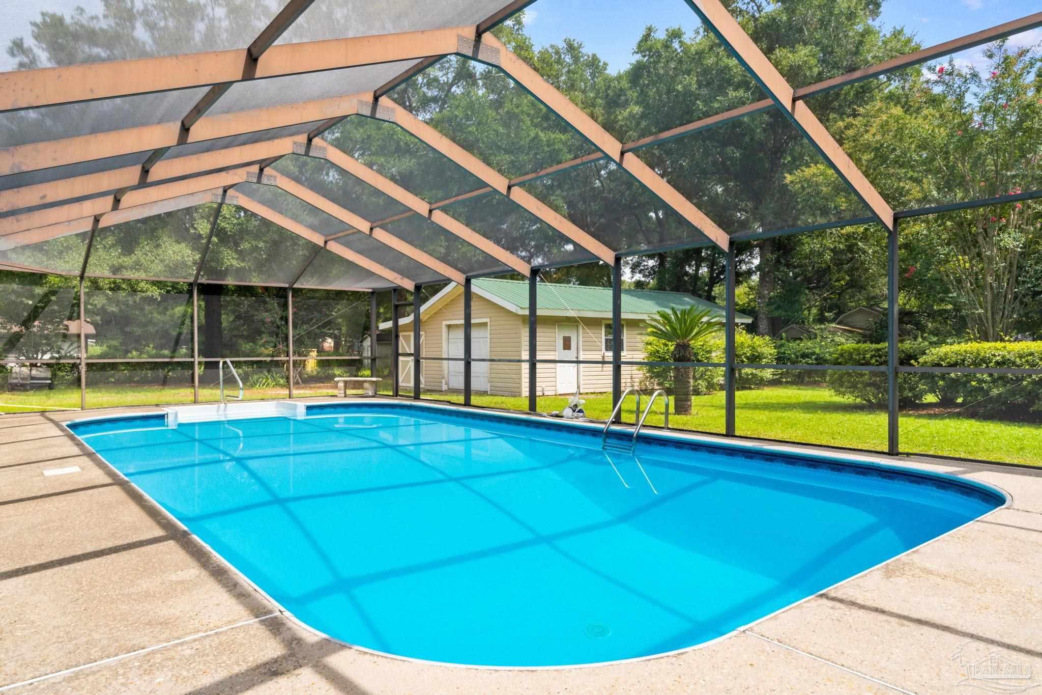 5645 Windham Road Milton, FL 32570 - Photo 34 of 40 a view of a swimming pool with a porch