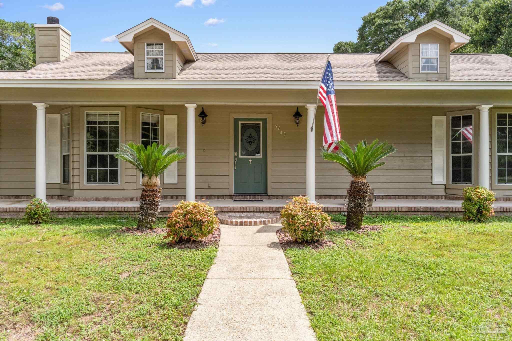 5645 Windham Road Milton, FL 32570 - Photo 4 of 40 a front view of a house with garden