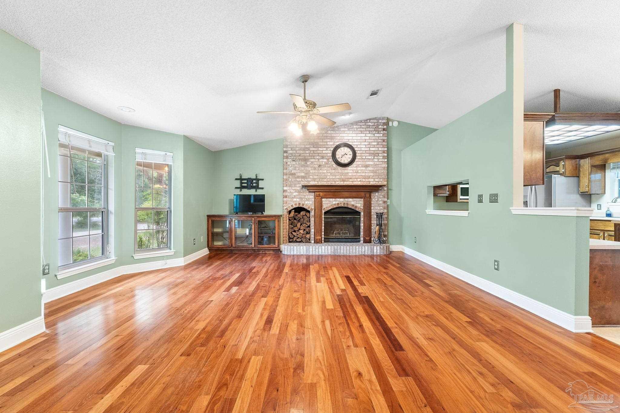 5645 Windham Road Milton, FL 32570 - Photo 6 of 40 a view of livingroom with fireplace and furniture