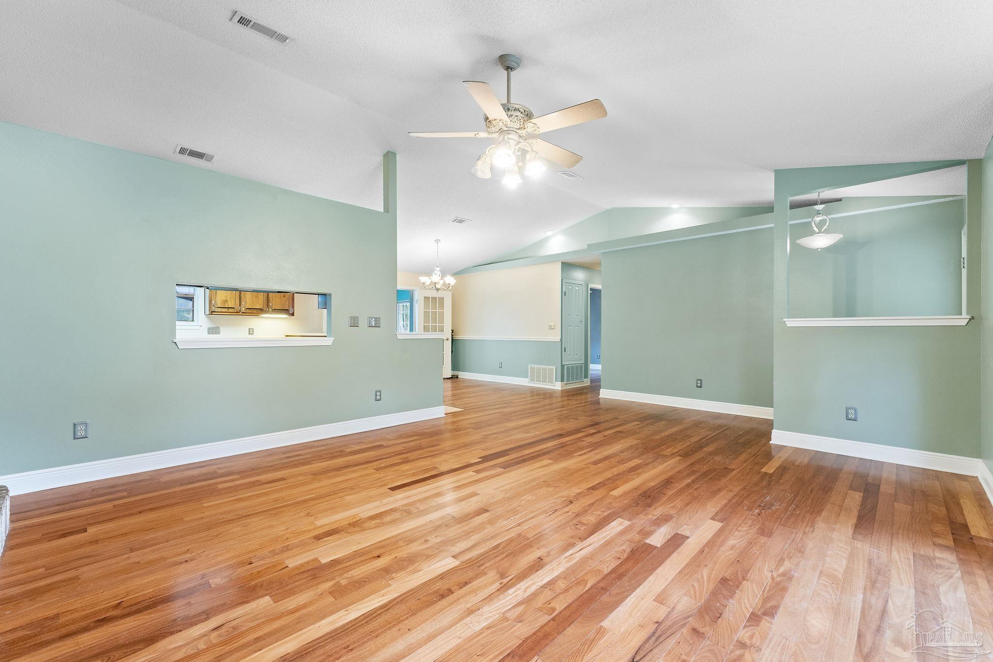 5645 Windham Road Milton, FL 32570 - Photo 9 of 40 a view of empty room with wooden floor and fan