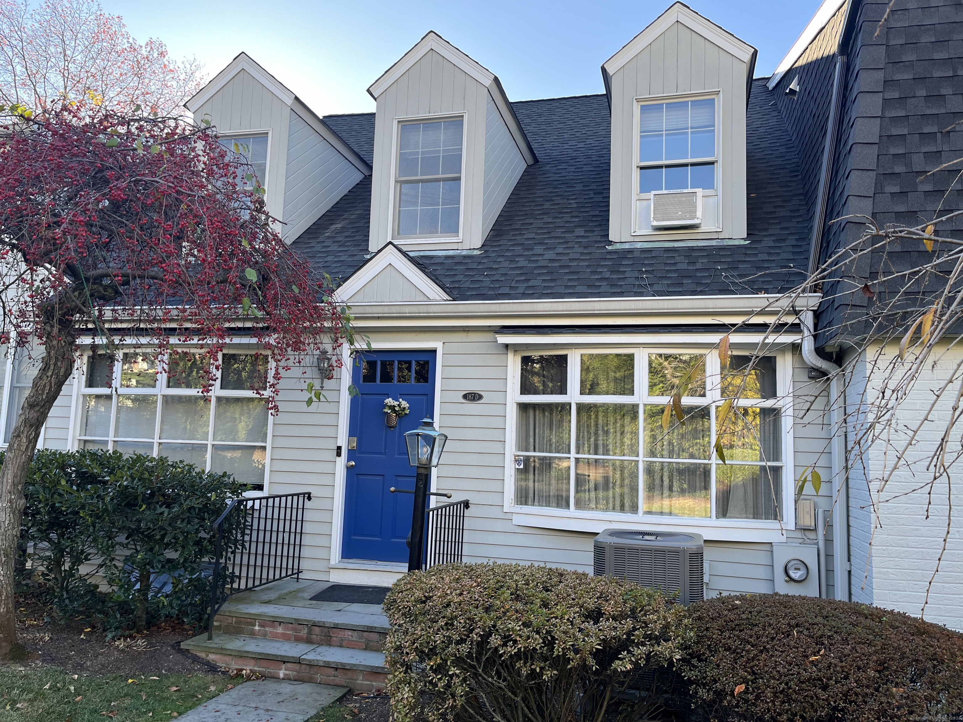 187 Park Street, Unit 9 New Canaan, CT 06840 - Photo 1 of 1 a front view of a house with a yard