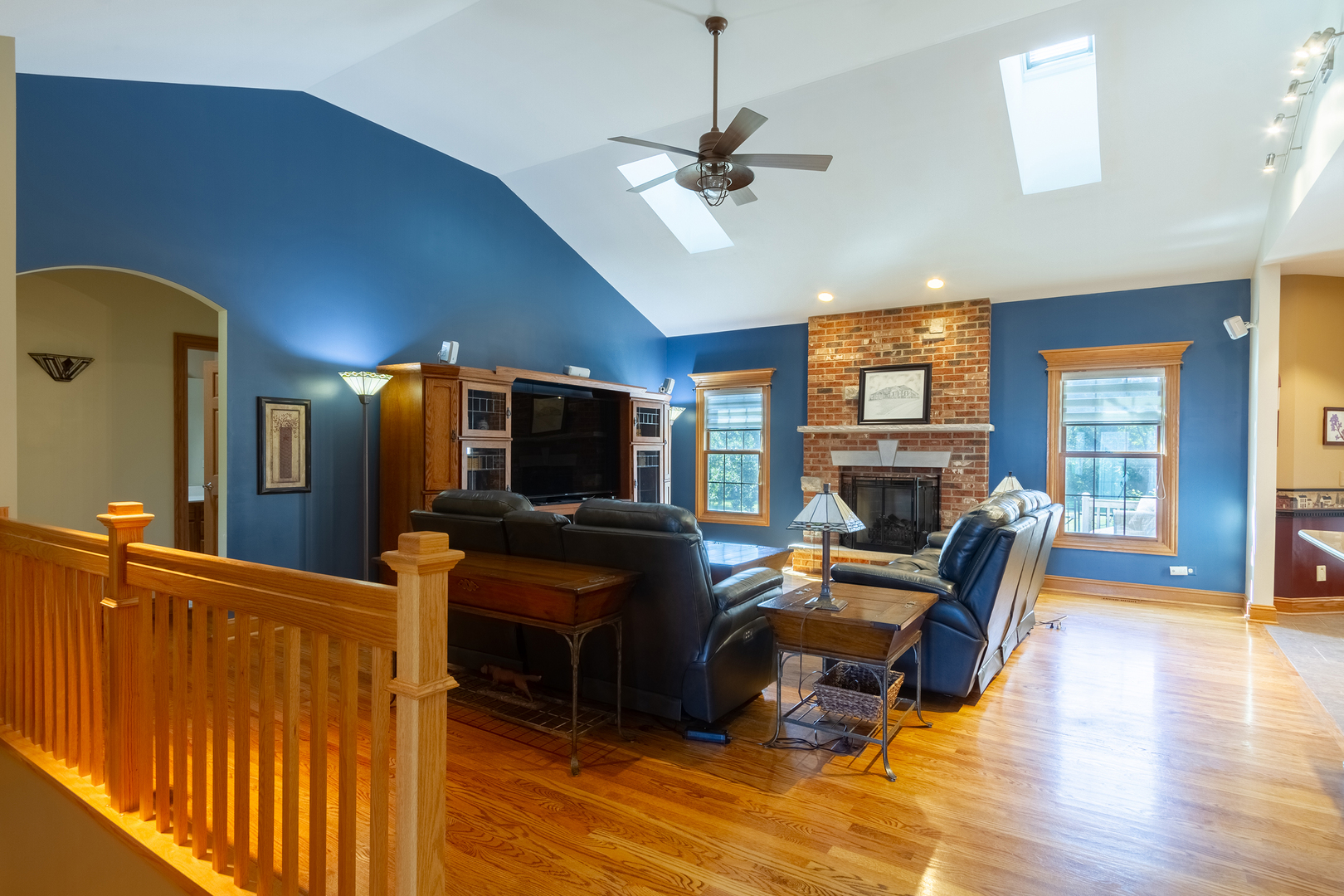 285 Valley Way Burlington, IL 60109 - Photo 19 of 40 a view of a livingroom with furniture a fireplace a flat screen tv and a chandelier
