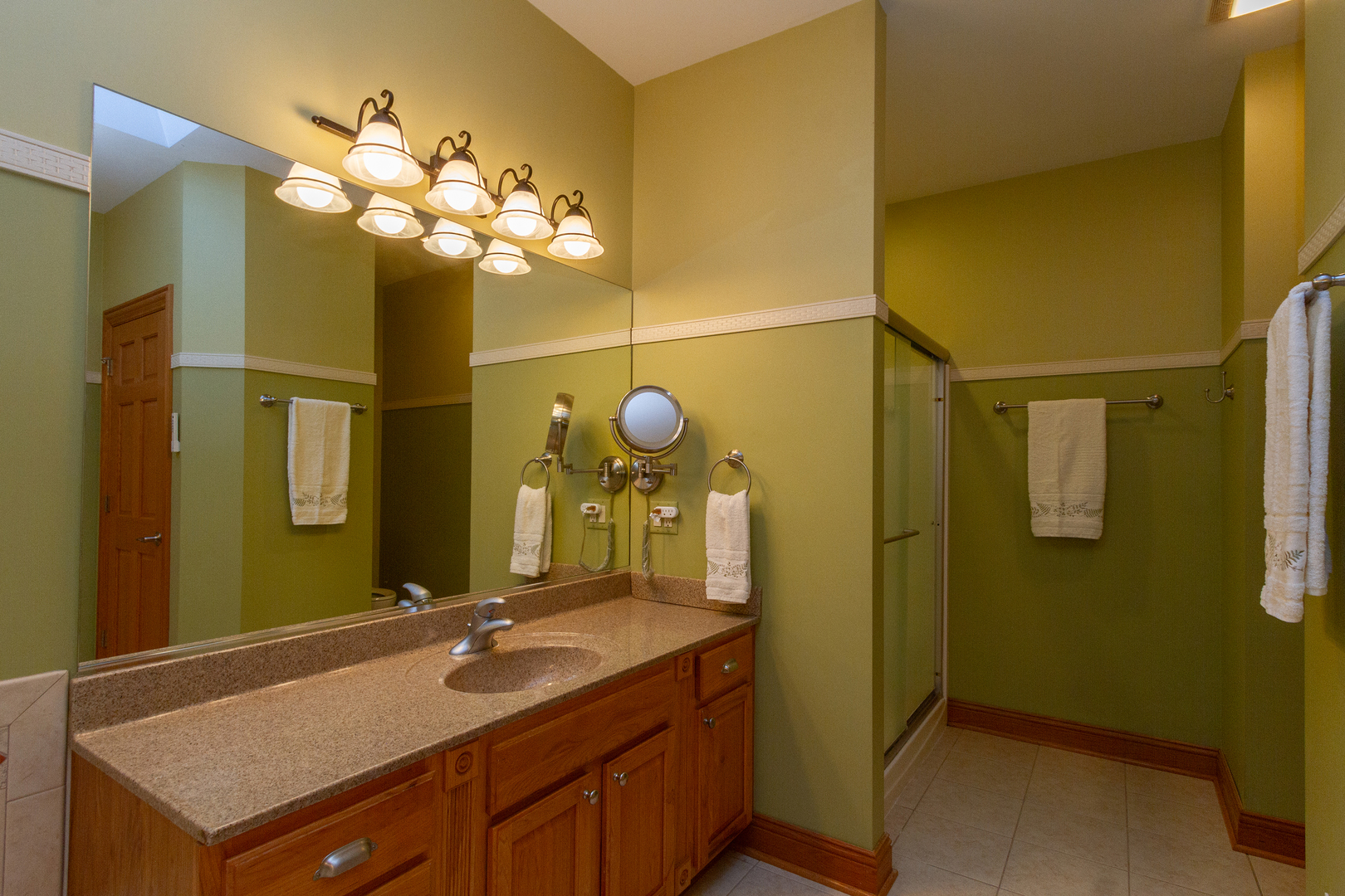 285 Valley Way Burlington, IL 60109 - Photo 24 of 40 a bathroom with a granite countertop sink and a mirror