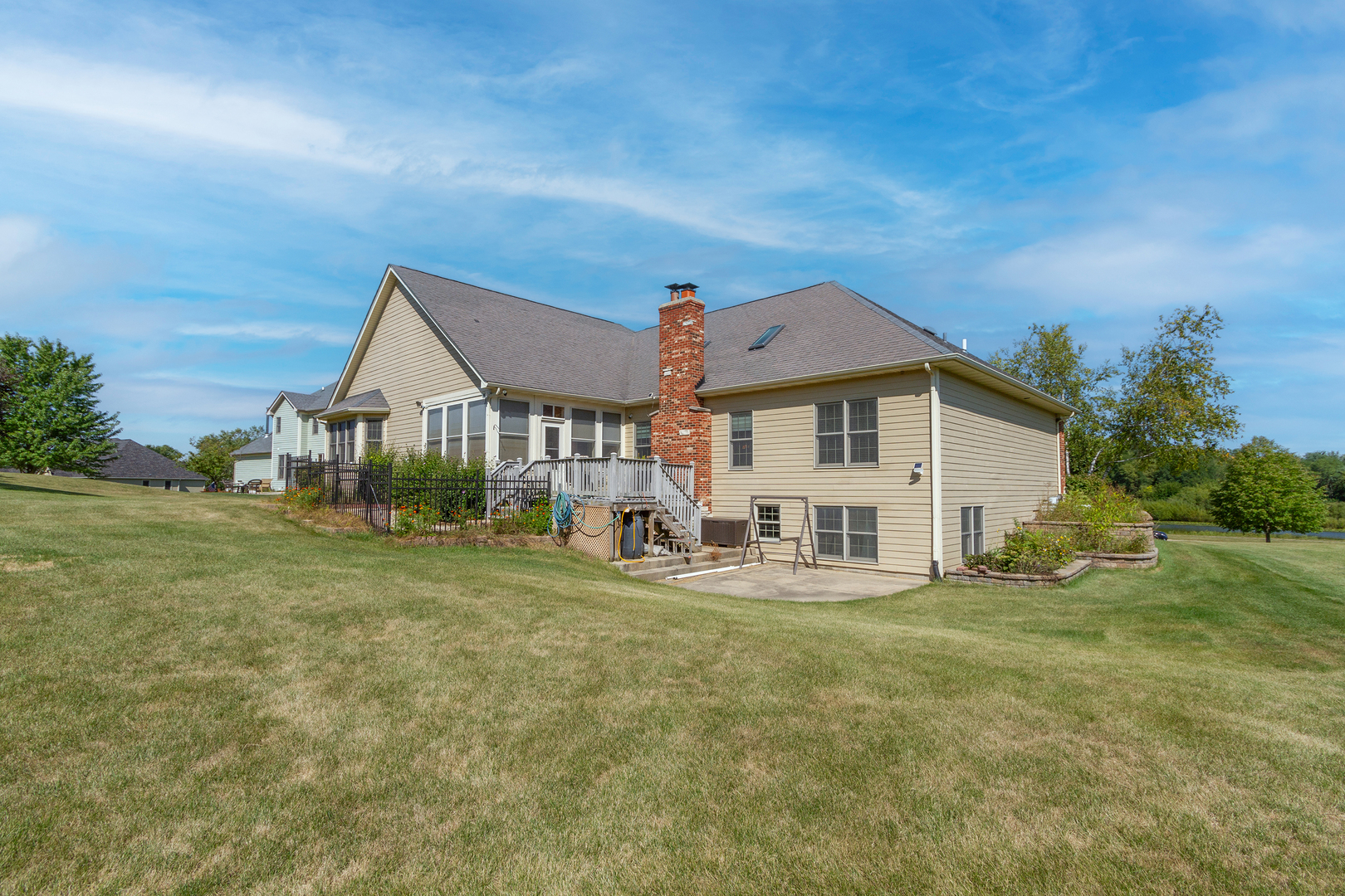 285 Valley Way Burlington, IL 60109 - Photo 32 of 40 a front view of a house with a yard table and chairs