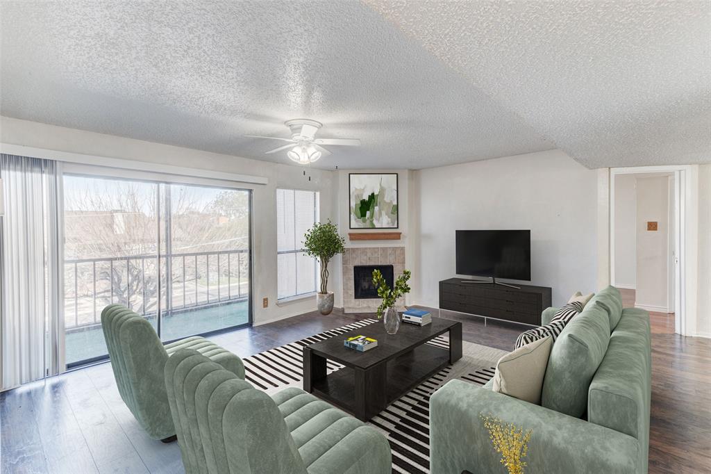 a living room with furniture a large window and a flat screen tv